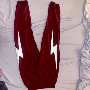 Size 10 burgundy polyester joggers. White Lightning bolts on side/not on back.